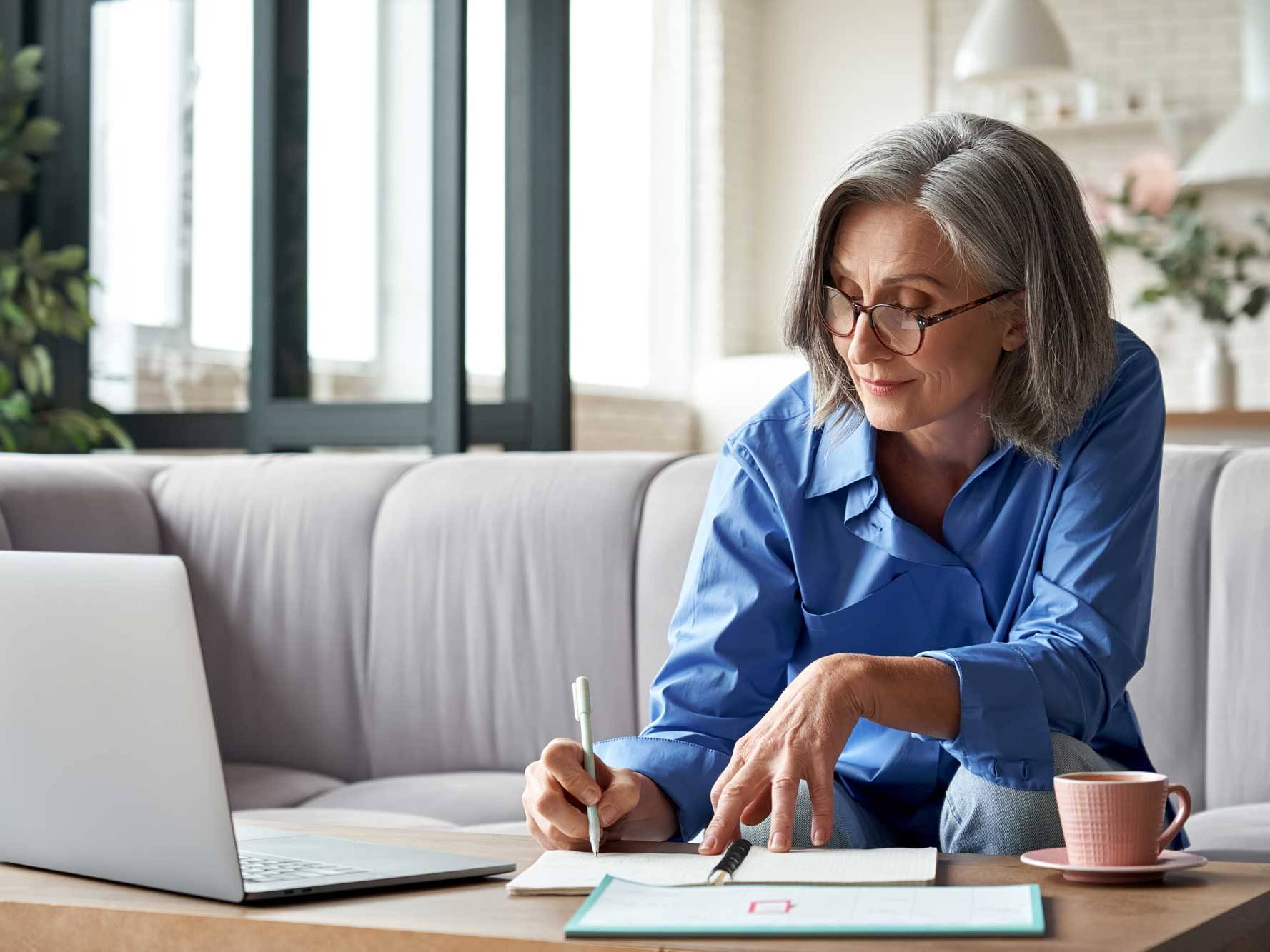 Woman is writing on her notebook